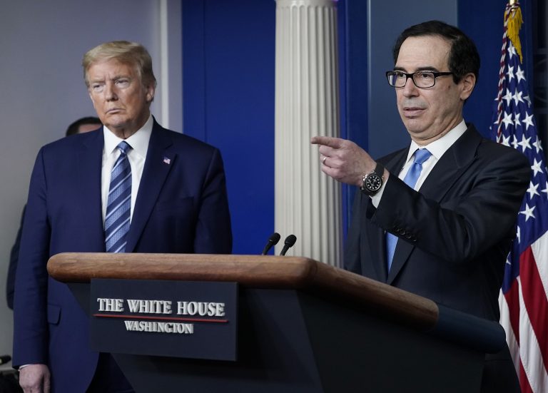 Treasury Secretary Steven Mnuchin speaks as U.S. President Donald Trump looks on during the daily coronavirus task force briefing at the White House on April 21, 2020 in Washington, DC. Earlier in the day, the president met with New York Gov. Andrew Cuomo in the Oval Office to discuss COVID-19 testing.