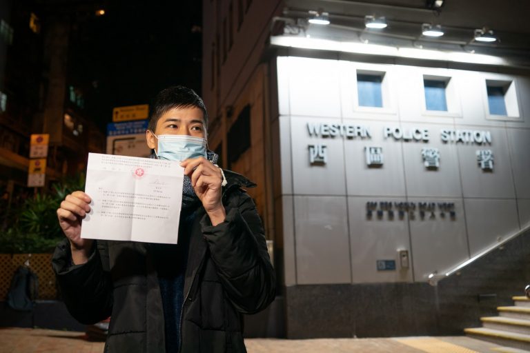 Pro-democracy activist Lester Shum shows his charge sheet to the members of the media after leaving Western Police Station on January 7, 2021 in Hong Kong, China. Over 50 Hong Kong opposition figures were arrested under the national security law in the largest operation yet against Beijing's critics, deepening a crackdown sweeping the financial hub. (Photo by Anthony Kwan/Getty Images)