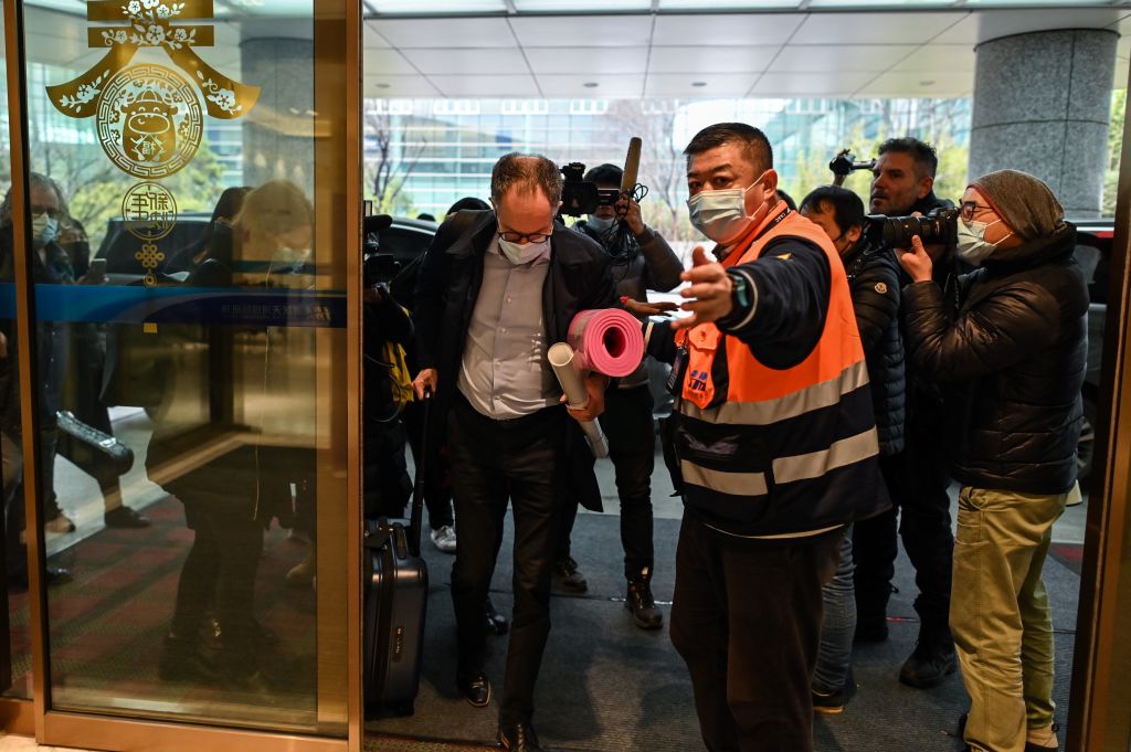 WHO team member Peter Ben Embarek (C) and other members of the group arrive at Tianhe International Airport to leave Wuhan in China's central Hubei province on February 10, 2021, after the team wrapped up an investigation into the coronavirus origin its team members described as clouded by politics