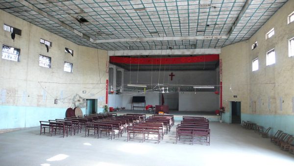 An old building, which the photographer speculates may have been a factory or sweatshop, has been converted into a makeshift Christian church in Changzhou, China.