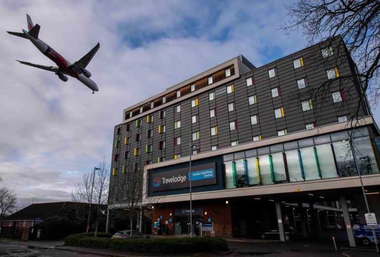 An airplane flies over a Travelodge Hotel as it comes in to land at Heathrow Airport on January 28, 2021 in London, England. New measures enacted by Prime Minister Boris Johnson’s government will leave citizens with heavy fines if they leave the country for reasons outside certain, limited exemptions.