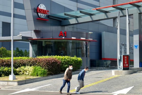 People walk past the headquarters of the world's largest semiconductor maker TSMC in Hsinchu on January 29, 2021. Taiwan is strengthening laws meant to prevent the Chinese Communist Party from stealing its tech industry's trade secrets and experts.
