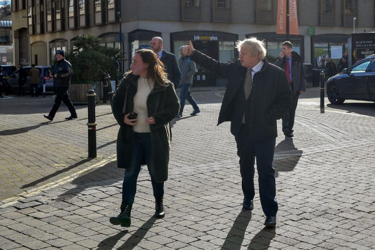 TRURO, ENGLAND - APRIL 07: British Prime Minister Boris Johnson (R) gives a thumbs-up to passers by as he walks to visit Ann's Cottage Surf Shop on April 7, 2021 in Truro, England. The Prime Minister visited businesses in Cornwall to see how they are preparing to reopen after the Coronavirus lockdown ahead of Step 2 of the roadmap on Monday 12 April.