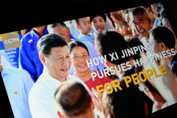 The title screen of a CCP propaganda segment titled "How Xi Jinping Pursues Happiness For People" from the CGTN archive is seen as it plays on a computer monitor on February 04, 2021, in London, England.