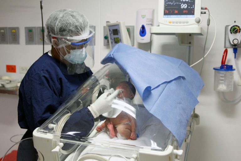 A nurse feeds a newborn with COVID-19 with donated milk