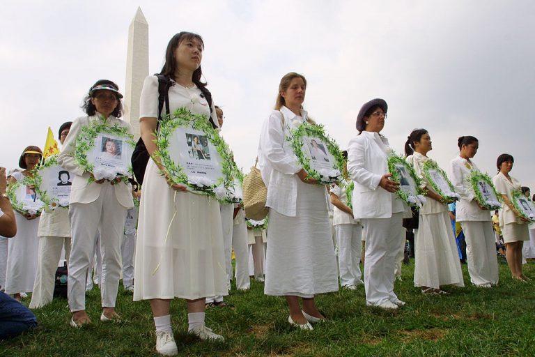 At a rally in Washington, DC July 19, 2001, Falun Gong practitioners hold photos of fellow members who died at the hands of the Chinese Communist Party, marking the second anniversary of Jiang Zemin’s persecution of Falun Gong, the largest spiritual group in China facing severe persecution.