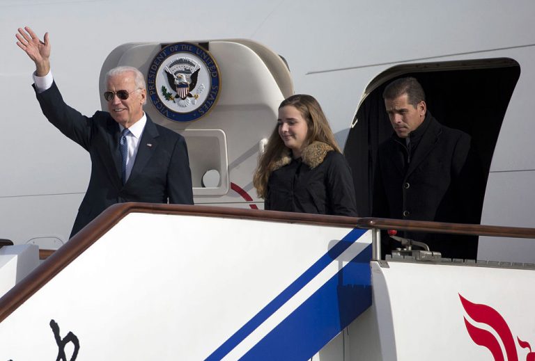 U.S. Vice President Joe Biden waves as he walks out of Air Force Two with his granddaughter Finnegan Biden and son Hunter Biden (R) on December 4, 2013 in Beijing, China.