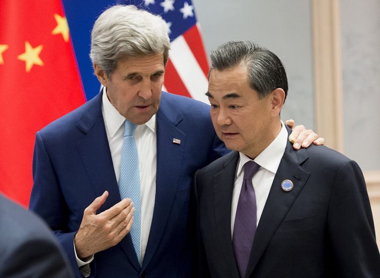 Former U.S. Secretary of State John Kerry speaks with Chinese Foreign Minister Wang Yi prior to the U.S. and China formally joining the Paris Climate deal at the West Lake State House in Hangzhou on September 3, 2016. The Biden administration has joined the Chinese Communist Party once again in making promises of changing the world in the name of climate change.