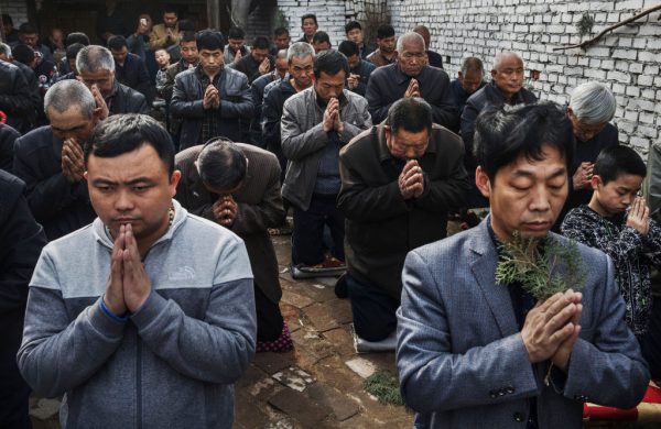 Chinese Catholic worshippers at Palm Sunday Mass during the Easter Holy Week at an unofficial church on April 9, 2017 near Shijiazhuang, Hebei Province, China. China places a number of restrictions on Christians, allowing legal practice of the faith only at state-approved churches. The policy has driven an increasing number of Christians to secretly congregate in private homes and other venues.