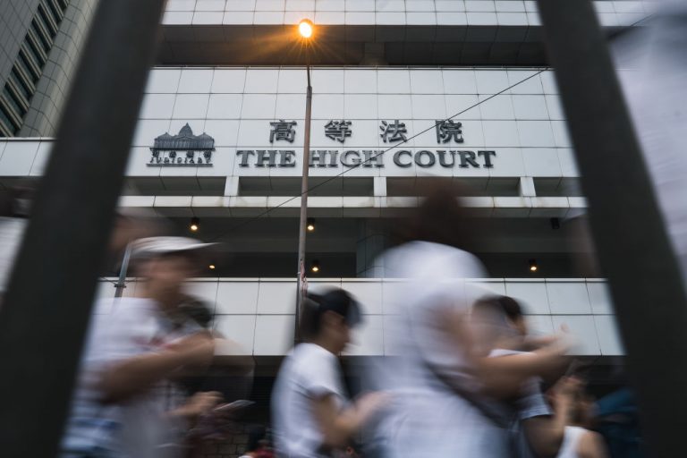 Hong Kong residents walk past the High Court in Admiralty during a protest against the government's controversial extradition law on June 9, 2019 in Hong Kong. The first person charged under the draconian, Beijing-installed National Security Law will be denied trial by jury.
