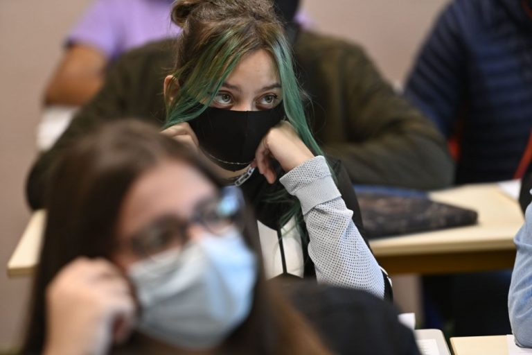 A girl wearing a mask sits in a classroom in Brequigny high school in Rennes, western France, on September 1, 2020. France’s Minister of National Education kiboshed the use of “woke” inclusive wording and the use of the French “midpoint” mechanic, fearing the language and its international reputation will otherwise be ruined.