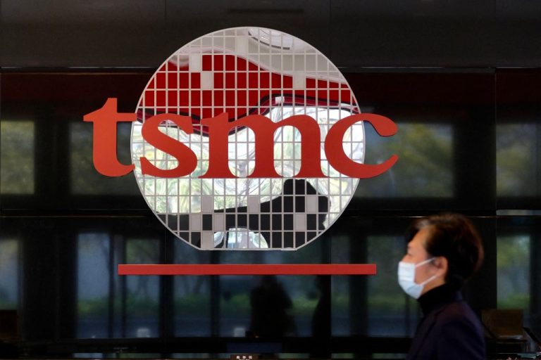 A man walks past a company logo at the headquarters of the world's largest semiconductor maker TSMC in Hsinchu on January 29, 2021. Sources say the world’s largest chip manufacturer will expand to build five more plants in Arizona in the next three years.