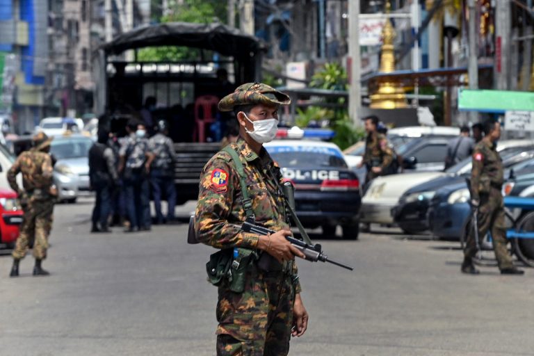 A soldier stands guard along a road as security forces search for protesters, who had been taking part in a demonstration against the military coup, in Yangon on May 7, 2021. A dead poet’s wife claims she found the organs missing from her husband’s body after it was returned to her by the Tatmadaw.