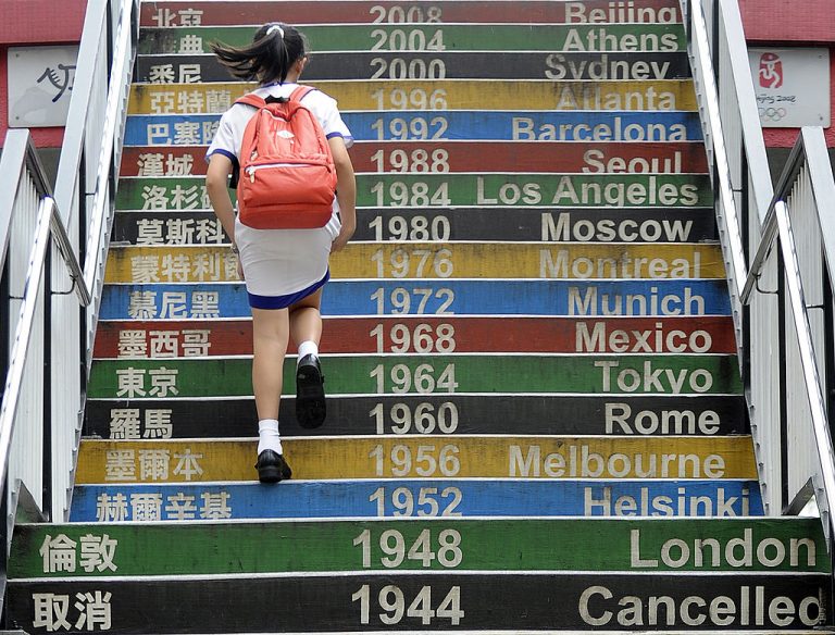 A student walks up stairs decorated with past Olympic dates in Hong Kong on June 13, 2012. SOAS University, formerly the School of Oriental and African Studies, has warned faculty members to protect students during classes on Chinese Communist Party-sensitive subjects fearing they can be arrested when entering Hong Kong or China for attending classes.