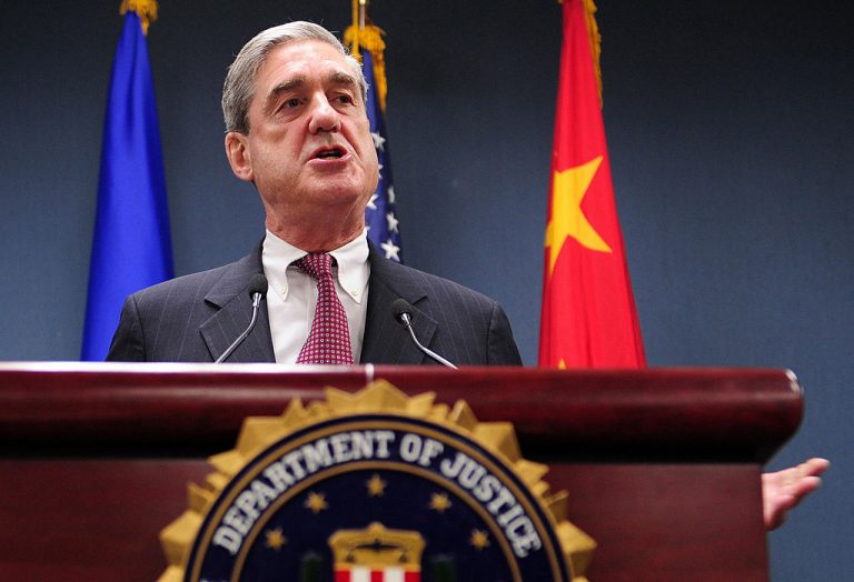 Robert Mueller, former head of the FBI, briefs the media at the U.S. Embassy in Beijing, 30 January 2008, after talks with the Chinese Communist Party. Mueller lauded the Party’s “anti-terrorism measures,” which cracked down on persecuted groups, democracy protestors, and people of spiritual faith, installed ahead of the 2008 Summer Olympics.