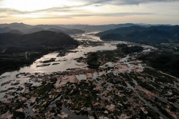 This aerial photo shows the Mekong River at Sangkhom district in the northeastern Thai province of Nong Khai, with Laos seen on the right, on October 31, 2019. Southeast Asia has the CCP’s lust for money to thank for the Mekong drought after its series of upstream dams withheld water to sell hydropower at 300 percent premiums.