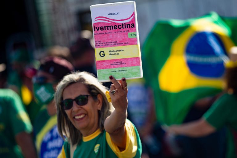 A supporter of President of Brazil Jair Bolsonaro holds a large box of Ivermectin, used by many people to treat the SARS-CoV-2 virus, on May 15, 2021 in Brasilia, Brazil. A recent study in the American Journal of Therapeutics that analyzed several other studies appeared to confirm the anti-parasitic drug, which also has antiviral properties, has meaningful value to COVID-19 treatment.