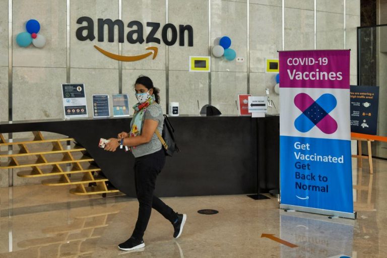 ’Like a Reverse Scarlet Letter’ An Amazon employee arrives to take a SARS-CoV-2 injection during a vaccination program for employees and their dependent family members at an Amazon India office building in Bangalore on June 5, 2021. Amazon will have vaccinated employees wear a green sticker on their badges to indicate their vaccinated status.