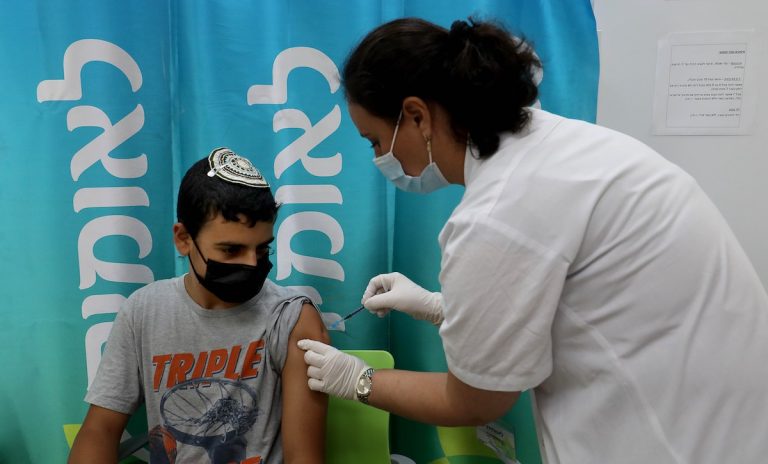 A medical worker administers the COVID-19 vaccine to a boy at a healthcare services center in central Israeli city of Modiin on June 22, 2021. Israel's Ministry of Health reported 139 new COVID-19 cases on Tuesday, raising the total number in the country to 840,079.