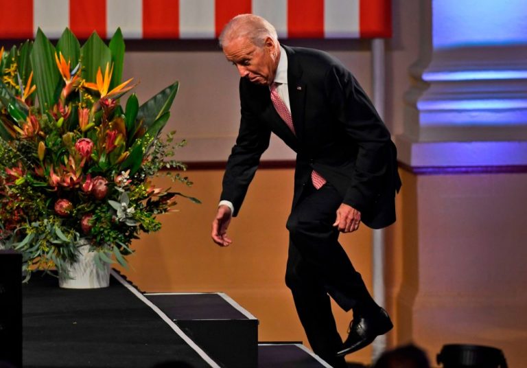 Former Vice President Joe Biden trips as he walks onto stage to deliver a speech at the Paddington Town Hall in Sydney on July 20, 2016. Biden plans to trap investors with a 20 percent capital gains tax hike in order to pay for $6 trillion in helicopter spending.