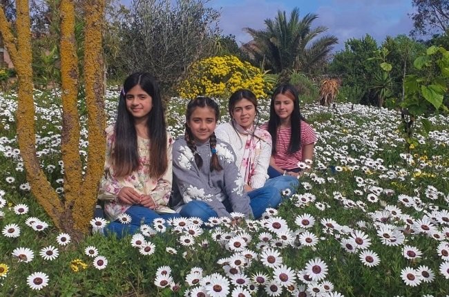 Sana Khan (20) and her sisters, Noor, Ilham and Asam, sitting among the Cape Coast flowers. The girls started their luxury honey brand, named Beelal Honey, during the national lockdown.