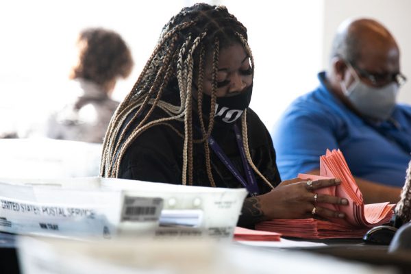 A Fulton county worker continues to count absentee ballots at State Farm Arena on November 6, 2020 in Atlanta, Georgia.