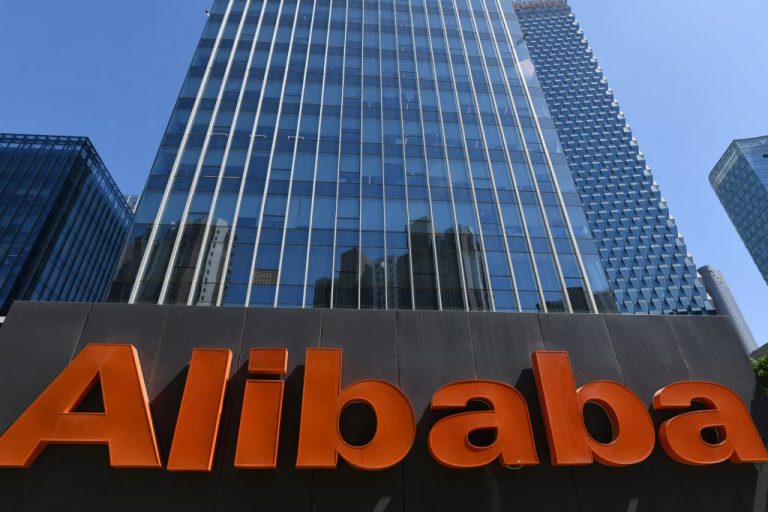 An Alibaba sign is seen outside the company's office in Beijing on April 13, 2021.