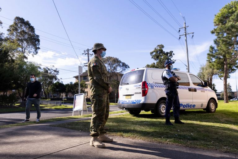 Police and Military are seen at the pop-up walk-in clinic at the Michael Wenden Aquatic Leisure Centre in Miller on August 05, 2021 in Sydney, Australia. COVID-19 lockdown restrictions in hot spot local government areas have increased with masks required outdoors at all times and residents limited to movement within a 5 kilometre radius of their homes. Greater Sydney is in lockdown through August 28th to contain the COVID-19 delta variant.