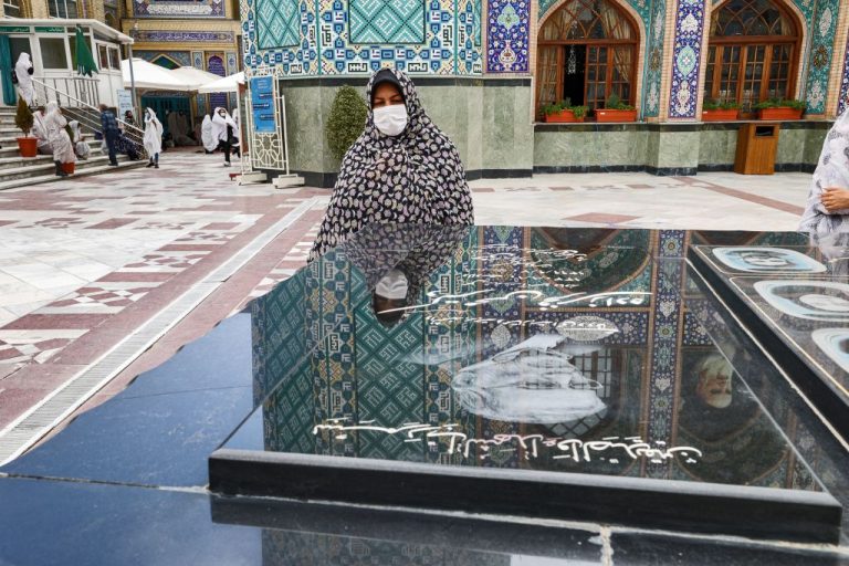 A woman pays her respects at the grave of Mohsen Fakhrizadeh, an Iranian scientist linked to the country's nuclear program who was killed months before by unknown assailants, at the Emamzadeh Saleh shrine in the Shemiran district of Iran's capital Tehran on April 14, 2021 on the first day of the Muslim holy fasting month of Ramadan in Iran.