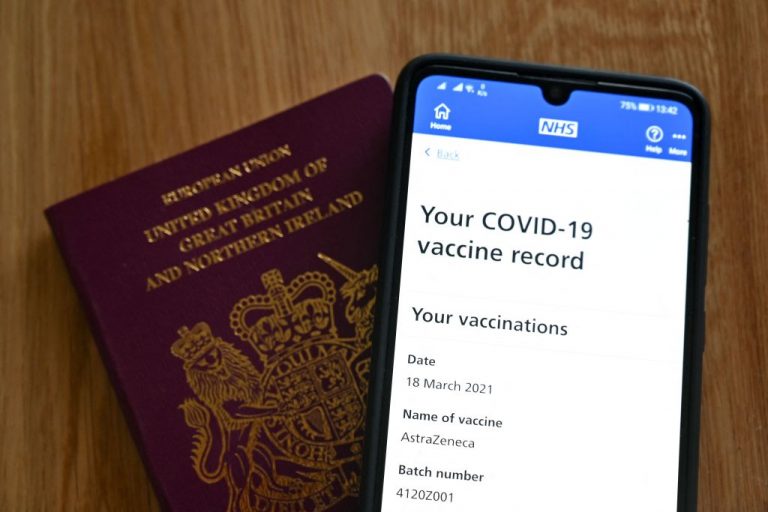 An illustration picture shows a smartphone screen displaying a Covid-19 vaccine record on the National Health Service (NHS) app in London on May 18, 2021.