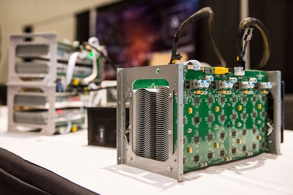 Bitcoin mining hardware is displayed at a Bitcoin conference at the Javits Center on April 7, 2014, in New York City. This specialized hardware, which consumes plenty of semiconductors amid a global supply shortage, does nothing but hash the SHA256 encryption algorithm used to win a reward by the Bitcoin software.