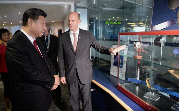 Chinese President Xi Jinping views models of satellites with Rupert Pearce, CEO of Inmarsat (R) during a visit to Inmarsat on October 22, 2015 in London, England. Recent investigations by the UK press reveal a startling buyup of Britain’s technology, education, energy, and business by Chinese Communist Party-owned and linked entities. 