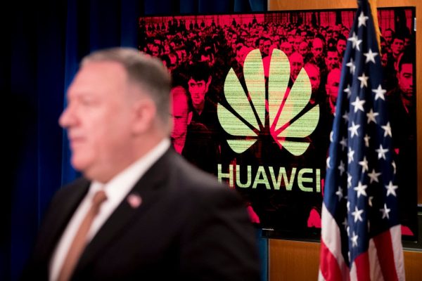 A monitor displays the logo for Huawei behind Secretary of State Mike Pompeo as he speaks during a news conference at the State Department in Washington, D.C. on July 15, 2020. Krach and Pompeo’s heavy blows against Huawei have left the CCP’s telecom giant in a state like a withering flower. 