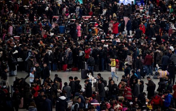 Passengers gather in the waiting hall at Hongqiao Railway Station ahead of the Lunar New Year holidays in Shanghai on February 6, 2018. China may be looking at losing its title of the world’s largest population to India as the nation, plagued by the long-term impact of negative Communist Party social policies, suffers an ever-worsening population crisis. 