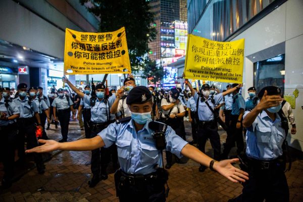 Police crowd control citizens as they gathered in the Causeway Bay district of Hong Kong on June 4, 2021, after the government closed a venue where Hong Kong people traditionally gather annually to mourn the victims of China's 1989 Tiananmen Square Massacre. 