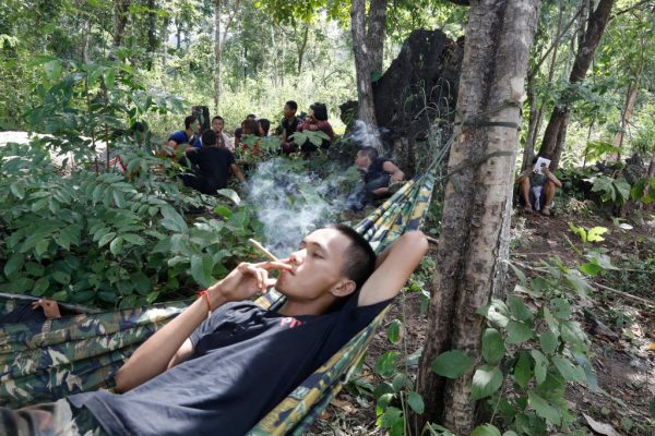This photo taken on October 9, 2021 shows members of the People's Defence Force, the armed wing of the civilian National Unity Government opposed to Myanmar's ruling military regime, resting at a camp in Kayin State, near the Myanmar-Thai border.  