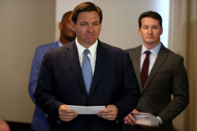 Governor Ron DeSantis waits to present a check to a first responder during an event at the Grand Beach Hotel on August 10, 2021 in Surfside, Florida. The Florida Department of Health fined Leon County $3.5 million for 714 counts of violating state legislation banning vaccine passports.