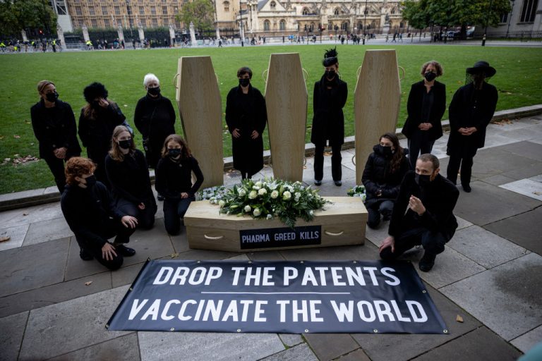 Protesters against vaccine patents pose for a photograph with cardboard coffins in Parliament Square on October 12, 2021 in London, England. A weekly COVID-19 Vaccine Surveillance Report by the UK Health Security Agency examining NHS data showed that while 98 percent of the country had antibodies against SARS-CoV-2 from either vaccination or natural exposure, the majority of cases over 40+ were still vaccine breakthroughs.