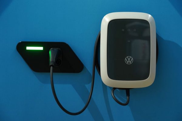 A wall charger for Voltswagen ID.3 and ID.4 electric cars hangs on display at the Autostadt promotional facility next to the Volkswagen factory on October 26, 2020 in Wolfsburg, Germany. While L2 wall charger costs $649 before installation, cost of fuel savings still do not offset the dramatic premium electric vehicles cost compared to their combustion engine counterparts. 