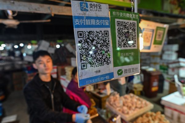 Alipay (L) and Wechat (R) QR payment codes are displayed at a market in Shanghai on October 27, 2020. 