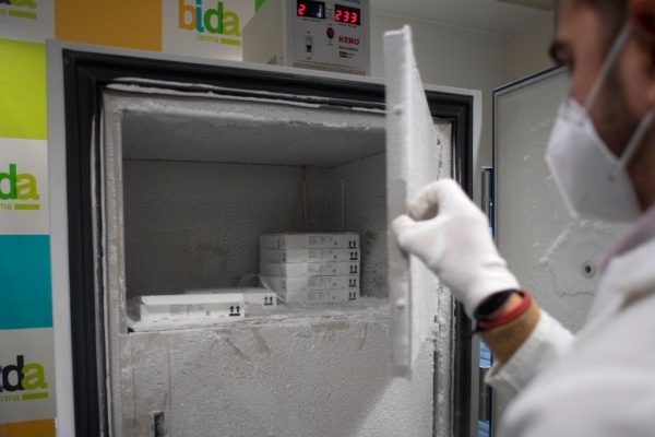 A laboratory technician stores Pfizer-BioNTech Covid-19 vaccines in a freezer at the Bidafarma wholesale distribution cooperative in Santa Fe, in the outskirts of near Granada, on January 21, 2021. 