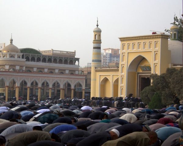 Hundreds of Uyghurs worship outside of Id Kah Mosque in Kashgar Prefecture, Xinjiang 
