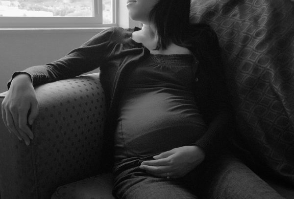 A husband captures a picture of his pregnant wife in her second trimester. Further research is needed to evaluate reports of COVID-19 vaccine miscarriages and stillbirths experienced soon after receiving the jab. 