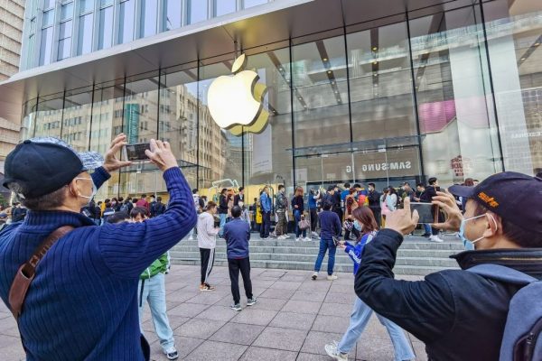 Customers queue to get their reserved iPhone 12 mobile phones at an Apple store in Shanghai on October 23, 2020. The Chinese Advertising Association, a CCP state-run entity, is working with Wechat’s Tencent and Tiktok’s ByteDance to circumvent Apple’s upcoming privacy upgrade in iOS 14.5. 