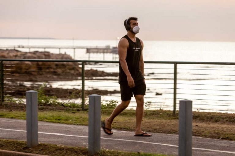 A Northern Territory resident suffers during the heat with a face mask during 23-hour COVID lockdowns.