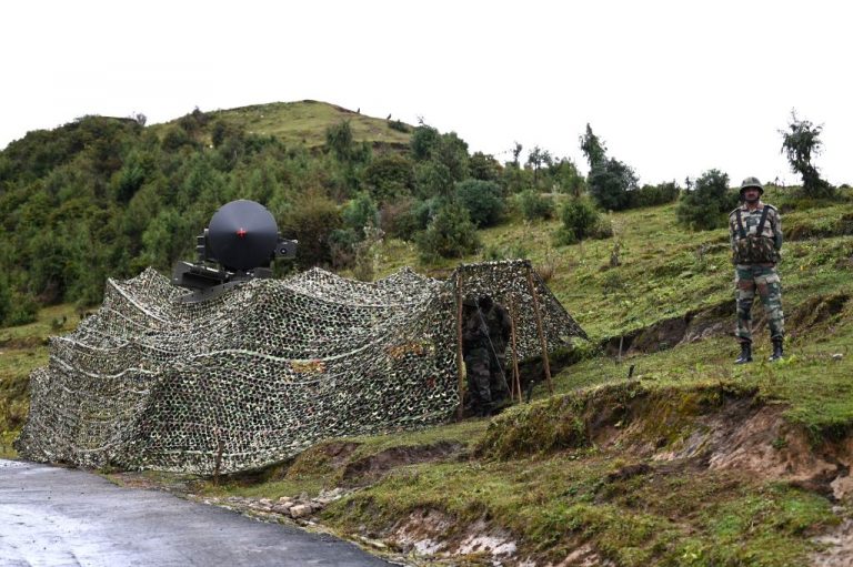 An Indian Army soldier stands next to a radar system which controls the upgraded L70 anti aircraft gun in Tawang, near the Line of Actual Control (LAC), in the northeast Indian state of Arunachal Pradesh on October 20, 2021.