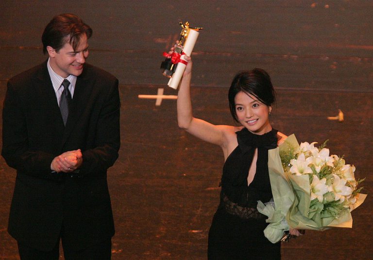 Chinese actress Zhao Wei celebrates after she is presented with the Best Actress Award by US actor Brendan Fraser at the closing ceremony of the 8th Shanghai International Film Festival on June 19, 2005 in Shanghai, China.