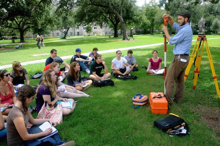 Man-teaches-students-outdoors-Wikimedia-Commons