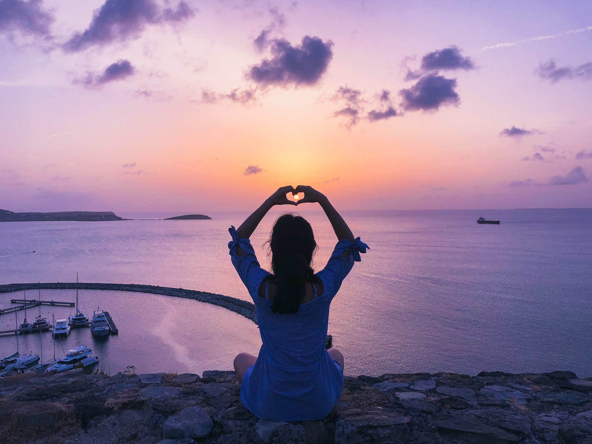woman-at-beach-during-sunset-making-heart-with-her-hands-Pexels