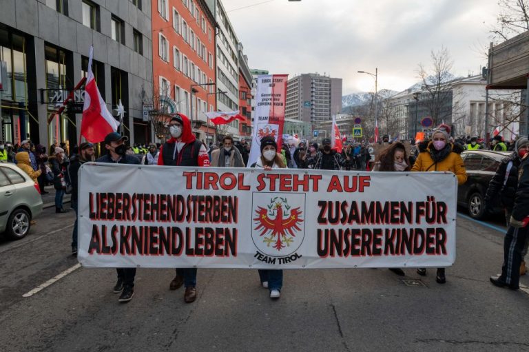 Protesters-banner-Tyrol-rises-demonstration-against-Austrian-measures-renowned-federal-vaccine-mandate-Dec.-12-2021-in-Innsbruck-Austria-Getty-Images-1237191459